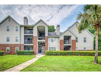 Charming condominium complex featuring brick accents, a well-manicured lawn, and lush landscaping at 2011 N Highway 17 # 1900G, Mount Pleasant, SC 29466