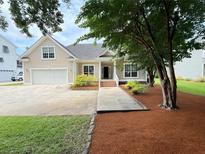 Charming single-Gathering home with well-maintained lawn, attached garage, and inviting entrance at 213 Ashmont Dr, Wando, SC 29492