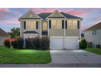 Charming two-story home with a well-maintained lawn, a two-car garage, and neatly trimmed bushes in the front yard at 3013 Argyll Dr, Summerville, SC 29483