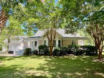 Charming single-story home with lush landscaping and mature trees in a desirable neighborhood at 5079 Coral Reef Dr, Johns Island, SC 29455