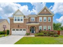 Charming two-story brick home with a well-manicured lawn and a two-car garage at 525 Yellow Tower Ter, Charleston, SC 29412