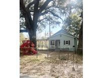 Charming single-story home featuring light blue siding, covered porch, and mature landscaping at 708 Francis St, Walterboro, SC 29488