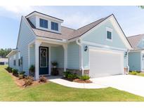 Charming light blue house with a two car garage, black door and well manicured yard at 754 Blue Iris Way, Summerville, SC 29486