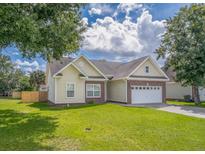 Charming single-Gathering home with manicured lawn and attached two-car garage at 7812 Spring Creek Rd, North Charleston, SC 29418