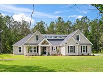 Charming single story home with a manicured lawn and inviting entrance at 0 Butterfly Ln, Awendaw, SC 29429