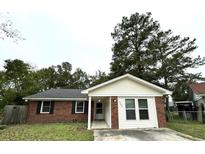 Charming brick and siding single-story home featuring a well-maintained front yard and welcoming entrance at 1005 Colony Ct, Summerville, SC 29486
