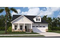 Charming one-story home featuring white siding, a covered front porch, and an attached two-car garage at 109 Barker Street, Summerville, SC 29486