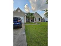 Charming single-story home with a well-manicured lawn, a driveway and a garage at 109 Dovetail Cir, Summerville, SC 29483