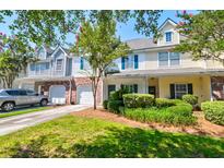 Townhome exterior with beautiful landscaping, driveway and garage at 143 Dorothy Dr, Charleston, SC 29414