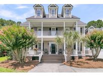 Charming two-story home with a double porch, lush landscaping and a welcoming entrance at 1436 Lagoon Park Cir, Mount Pleasant, SC 29466