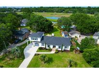 Exterior shot of home boasting manicured front lawn and mature landscaping at 1468 N Relyea Ave, Charleston, SC 29412