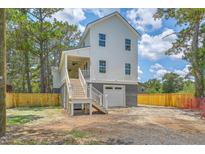 This home features a white exterior, a one car garage, and a covered porch with stairs at 1685 Old Military Rd, Charleston, SC 29412
