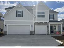 Charming two-story home featuring a three-car garage and stone accents at 178 Grange Cir, Summerville, SC 29486