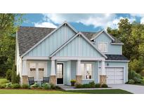 Charming blue two-story home with landscaped yard and inviting front porch at 235 Denham St, Summerville, SC 29486