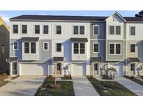 Charming townhome exteriors with attached garages and professional landscaping create an inviting curb appeal at 469 Caledon Ct, Johns Island, SC 29455