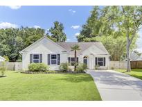 Charming single-story home with a manicured lawn, driveway, and well-maintained landscaping at 5406 Dwight Dr, North Charleston, SC 29420