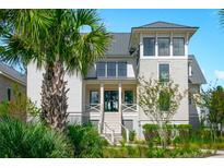 Charming two-story home featuring lush landscaping and a welcoming front porch at 810 Bosuns Pt, Charleston, SC 29492