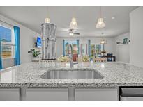Granite countertops accent this eat-in kitchen with pendant lighting and stainless steel appliances at 9700 Flooded Field Dr, Ladson, SC 29456