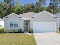 Inviting single-story home featuring neutral siding, an attached garage, and manicured landscaping in the front yard at 123 Lagoona Dr, Summerville, SC 29483