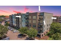 Stunning condominium complex with a mix of brick and siding, lush landscaping, and ample parking at 125 Pier View St # 408, Charleston, SC 29492