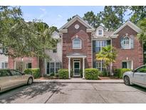 Charming brick townhouse featuring manicured landscaping and a welcoming front entrance at 1682 Camfield Ln, Mount Pleasant, SC 29466