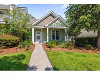 Charming home with a manicured lawn and inviting walkway leading to the front door at 2961 Sweetleaf Ln, Johns Island, SC 29455