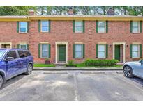 Charming brick townhouse with green shutters and well-maintained landscaping at 302 Springview Ln # 7, Summerville, SC 29485