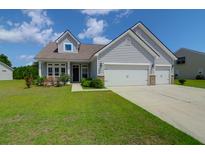 Charming home featuring a manicured lawn, two-car garage, and welcoming curb appeal at 3524 Great Egret Dr, Johns Island, SC 29455