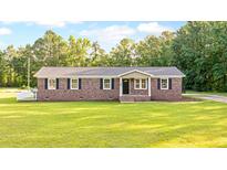 Charming brick home features a manicured lawn and classic shutters at 400 Black Oak Rd, Bonneau, SC 29431