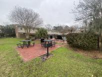 Community pool and picnic area with black tables, grills, and landscaping in a residential community at 415 Parkdale Dr # 6D, Charleston, SC 29414