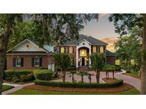 Stately brick home with a circular driveway, manicured landscaping, and a grand entrance at 510 Traders Aly, Mount Pleasant, SC 29464