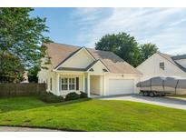 Charming single-Gathering home featuring a two-car garage, well-kept lawn, and an asphalt driveway at 518 Cecilia Cove Dr, Charleston, SC 29412