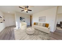 Bright living room featuring modern furnishings, ceiling fan, and neutral color palette at 5306 Bending Flats Way, Summerville, SC 29485