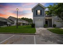 Charming townhome with attached garage and well-maintained lawn at twilight at 540 Truman Dr, Goose Creek, SC 29445
