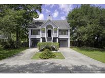 Charming two-story home with symmetrical design, well-maintained landscaping and double garage, offering curb appeal at 633 Stono Edge Dr, Charleston, SC 29412