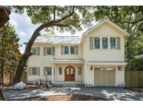 Beautiful two-story home with cream siding, a metal roof, and a spacious garage at 743 Hills St, Mount Pleasant, SC 29464