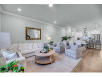 Bright living room features contemporary furnishings and stylish decor throughout the space at 7633 Indigo Palms Way, Johns Island, SC 29455