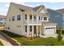 Charming two-story home featuring a welcoming porch, attached garage, and manicured lawn at 791 Maynard Ln, Summerville, SC 29486