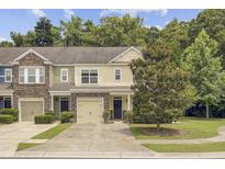 Charming townhome with a well-manicured lawn, lovely landscaping, and a traditional facade at 810 Bibury Ct, Charleston, SC 29414