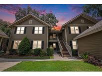 Inviting two-story condo with well-maintained landscaping and a beautiful exterior paint job at sunset at 8327 Childs Cove Cir, North Charleston, SC 29418