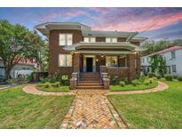 Charming two-story brick home with a welcoming front porch and beautiful brick walkway at 88 Smith St, Charleston, SC 29401