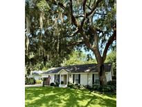 Charming one-story home with a manicured lawn and a majestic moss-draped live oak tree at 958 Night Heron Dr, Mount Pleasant, SC 29464