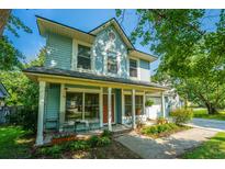Charming two-story home with a welcoming front porch, landscaped yard, and inviting curb appeal at 103 Toura Ln, Charleston, SC 29414
