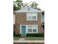 A cozy townhome showcases a charming brick exterior and a vibrant turquoise front door at 124 Brush Blvd, Goose Creek, SC 29445