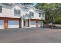 Inviting two-story townhouse featuring attached garages and a manicured lawn at 1604 Basildon Rd, Mount Pleasant, SC 29466