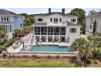 Luxury home featuring a swimming pool, screened in porch and spacious back yard at 1636 Rivertowne Country Club Dr, Mount Pleasant, SC 29466