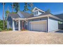 Charming blue home with a two-car garage and brick-paved driveway at 1641 Adventure Xing, Mount Pleasant, SC 29466