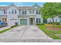 Charming two-story home featuring a green garage door and manicured lawn at 1666 Bridwell Ln, Mount Pleasant, SC 29466