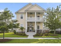 Charming two-story home featuring a welcoming porch, balcony, and beautifully landscaped front yard at 1713 Banning St, Mount Pleasant, SC 29466