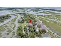 Stunning aerial view of marsh-front townhomes in a desirable waterside community at 202 Mariners Cay Dr, Folly Beach, SC 29439